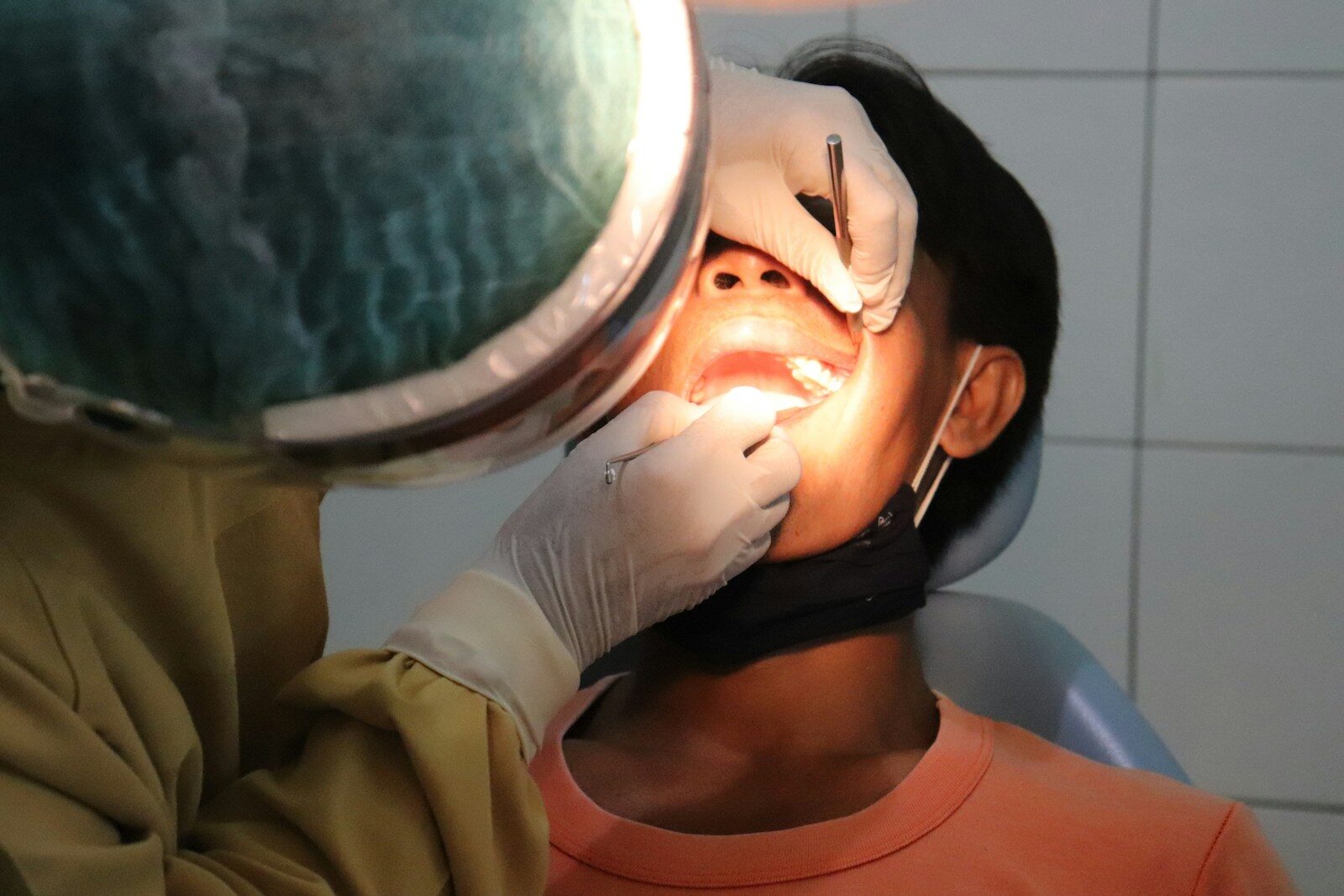 Photo by Diana Polekhina a man getting his teeth checked by a dentist
